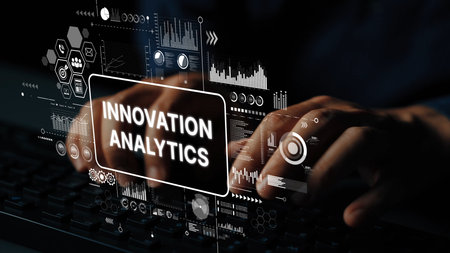 Hands Typing on a Keyboard with Digital Analytics and Innovation Graphics in a Modern Workspace Setting.の写真素材