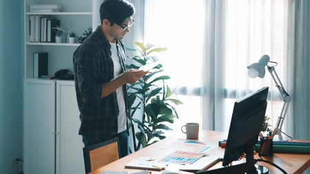 Top view of smart business man calling manager while choose color. Professional interior designer looking at laptop screen while select and design main theme color for product at meeting. Symposium.の写真素材