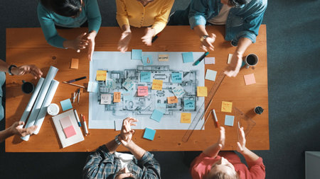 Top down view of business team work together and putting fist together at meeting room. Aerial view of skilled architect engineer making circle from fist. Represented love, unity, teamwork. Symposium.の写真素材