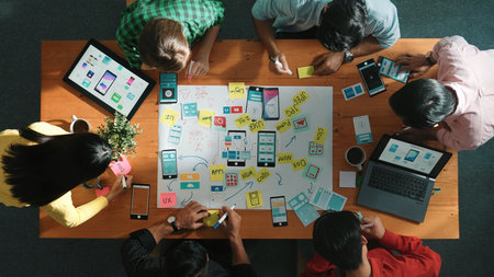 Professional developer team sharing idea of Ux Ui design by using mind map. Top down view of group...