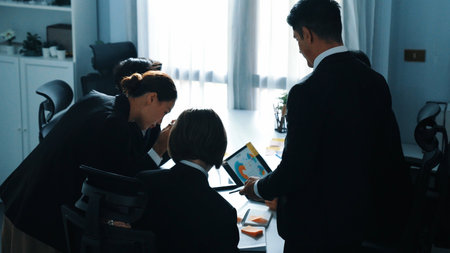 Top view of professional business people looking at financial chart from tablet while diverse group brainstorming marketing idea by using and writing sticky notes at business conference. Directorate.の写真素材