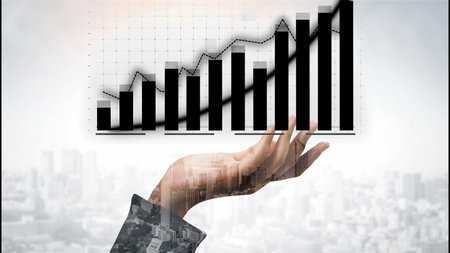 A hand symbolizes aspiration and growth, showcasing financial graphs that represent success and business opportunities in a modern urban setting.の写真素材