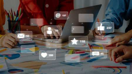 A dynamic office scene showcasing a creative team engaged in social media project work. The image highlights collaboration, technology, and data visualization. Rasterの写真素材