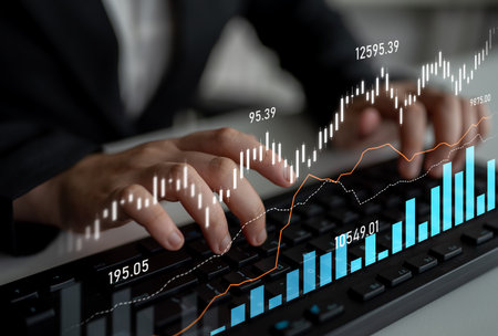 A business professional focused on financial analysis, using a modern keyboard while stock market...
