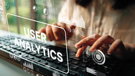 Professional hands typing on a keyboard with digital user analytics graphics in foreground showcasing data insights and technology concepts. Asymptotic smart data analytic.の写真素材