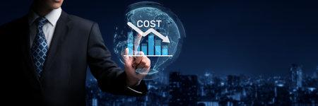 A business professional analyzes cost reduction strategies using data graphs in a corporate...