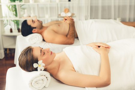 Caucasian couple customer enjoying relaxing anti-stress spa massage and pampering with beauty skin recreation leisure in day light ambient salon spa at luxury resort or hotel. Quiescentの写真素材