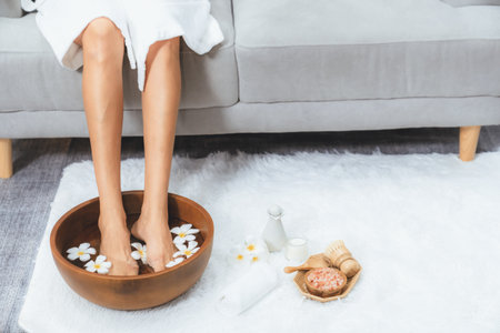 Panorama top view woman indulges in blissful foot massage at luxurious spa salon while masseur give reflexology therapy in gentle day light ambiance resort or hotel foot spa. Quiescentの写真素材