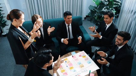 Top view of business people putting hands together and clapping hands to celebrate successful...