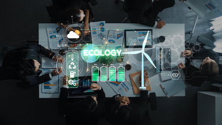 Aerial view of a business meeting focused on ecology and renewable energy topics. Charts and wind...