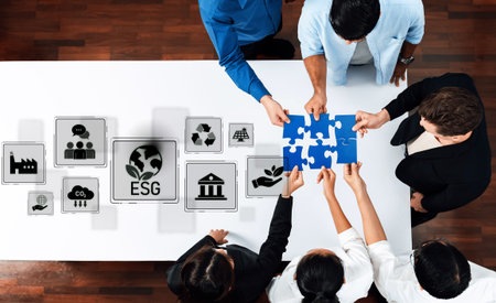 A group of diverse professionals collaborates around a table, assembling puzzle pieces to symbolize...