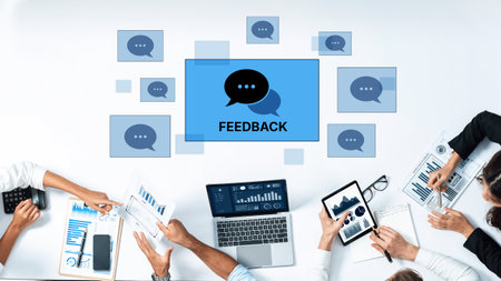 Engaging teams in a modern office setup, showcasing feedback through digital devices. Ideal for conveying collaboration, communication, and productivity themes.の写真素材