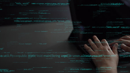 Close-up view of hands actively typing on a laptop while surrounded by floating snippets of code, representing modern programming and technology.の写真素材