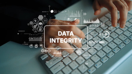 Hands Typing on Keyboard with Data Integrity Concept and Graphics Overlay Representing Security and...