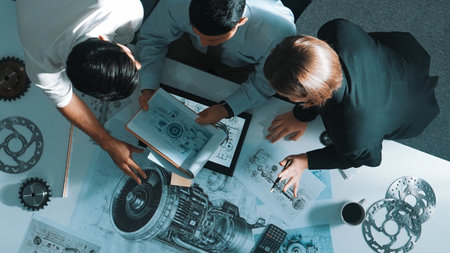 Top down view of skilled engineer working together while looking at jet engine. Aerial view of smart...