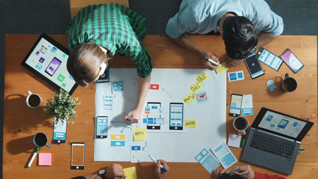 Professional developer team sharing idea of Ux Ui design by using mind map. Top down view of group of business people working together to brainstorm or plan mobile phone interface app. Convocation.の写真素材