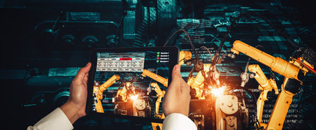 Engineer controls robotic arms by augmented reality industry technology application software. Smart robot machine in future factory working in concept of Industry 4.0 or 4th industrial revolution.の写真素材