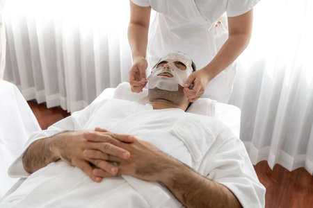 Serene modern daylight ambiance of spa salon, customer indulges in rejuvenating with facial skincare mask. Facial skin treatment and beauty cosmetology procedure for face. Quiescentの写真素材
