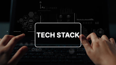 Hands Typing on Laptop with Tech Stack Graphics Displaying Complex Technology Concepts and Data...