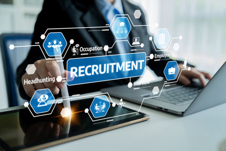 A professional businessman is engaged in the recruitment process, using digital tools like a tablet and laptop to streamline hiring and improve efficiency. Tesselの写真素材