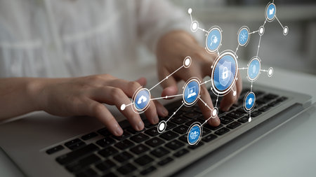 This image captures hands typing on a laptop, surrounded by icons symbolizing security and...