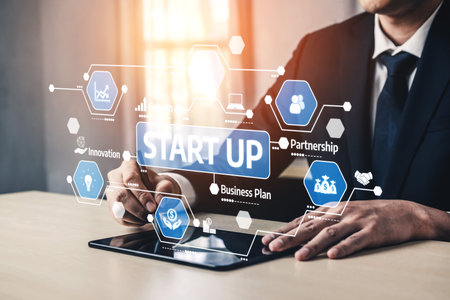 A professional examines startup ideas using a tablet in a modern workspace, showcasing innovative digital solutions and partnership strategies for business success. Tesselの写真素材