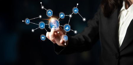 A business professional engages with a digital touchscreen interface, highlighting innovative technology concepts and network connectivity in a modern workspace environment.の写真素材