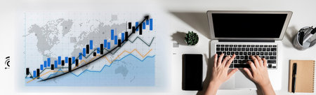 A modern office scene featuring a dynamic graph on a digital tablet and hands typing on a laptop, symbolizing business growth, strategy, and data analysis. Imputeの写真素材