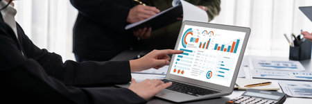 Panorama shot analyst team utilizing BI to analyze financial report with laptop. Businesspeople...