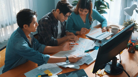 Top view of project manager looking at screen while designer writing idea. Close up of smart business team explain idea of logo design while designer choose theme while looking at palette. Symposium.の写真素材