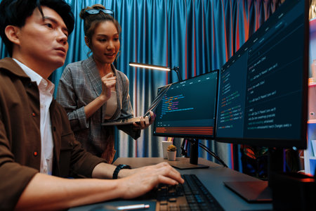 Serious of IT developers discussing intelligent website development coder system running data online two screens with laptop showing information network at neon light room at modern office. Infobahn.の写真素材