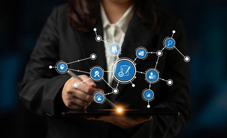 A business professional interacts with a tablet displaying e-commerce icons connected through a digital network, showcasing technology role in modern commerce. Tesselの写真素材