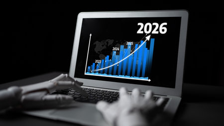 A sleek laptop displays a growth chart with a robotic hand suggesting innovation in data analysis....