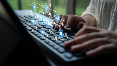 A focused shot of hands typing on a keyboard, surrounded by vibrant digital marketing icons, illustrating the fusion of technology and business in a modern workspace. Tesselの写真素材