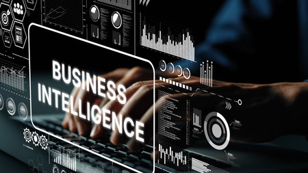 Hands Typing on Laptop with Business Intelligence Visuals and Data Analytics Icons in Modern Office Environment. Asymptotic smart data analytic.の写真素材