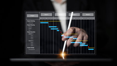 Person Using Stylus to Interact with Visual Project Management Gantt Chart on Tablet Display with Focused Expressions in Modern Business Environment.の写真素材