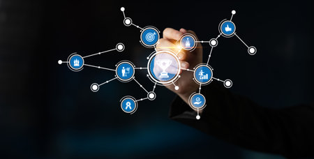 A hand interacts with a digital interface showcasing a network of icons, symbolizing communication and data connection in a modern business environment. Tesselの写真素材