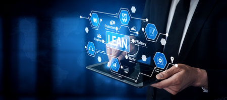 A business professional interacts with a tablet displaying lean management concepts. Focused on improving efficiency, waste reduction, and organizational success.の写真素材