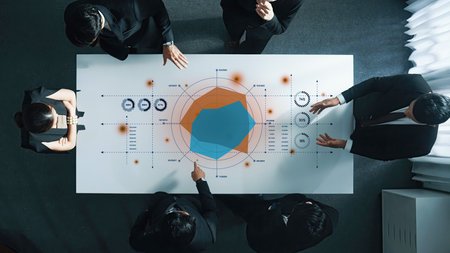 A dynamic business meeting showcasing professionals collaborating on strategy and financial...