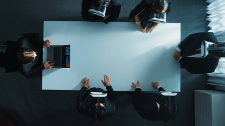 Top down aerial view of diverse data analysts wearing VR headset and stand around table while using hand gestures to manipulate the data streamed live from executive managers laptop. Directorate.の写真素材