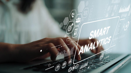 Hands on Keyboard with Digital Smart Analytics Graphics and Data Visualization Overlay Representing...