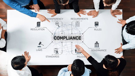 Aerial view of a diverse group of professionals discussing compliance strategy with focus on...