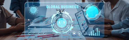 Professionals collaborating in a modern office setting utilize a digital interface to explore global business trends and data insights for strategic planning.の写真素材