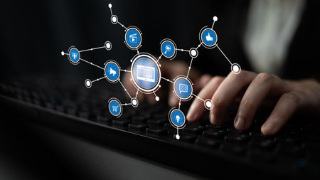 A concept image showcasing hands typing on a keyboard, surrounded by floating icons that symbolize...