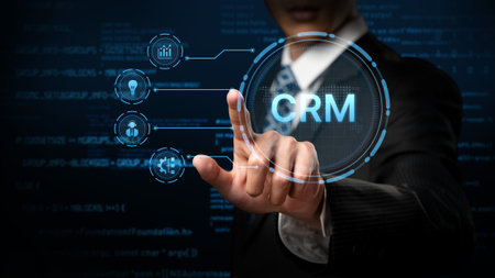 A business professional in a suit interacts with a digital CRM interface, symbolizing modern customer relationship management and data-driven strategies in a corporate setting.の写真素材