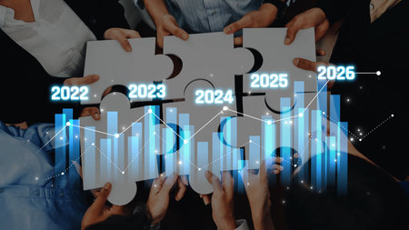 Diverse hands hold puzzle pieces symbolizing teamwork and collaboration, alongside a graphical representation of growth projections, embodying future business strategy. Rasterの写真素材