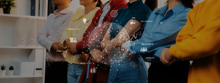 A diverse group of professionals standing together, arms crossed, with a digital interface overlay symbolizing collaboration, innovation, and networking in a modern business environment.の写真素材