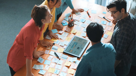 Top view of skilled programmer brainstorming idea about mobile phone interface while develop app development by using wireframe prototype. Web designer planning at table with sticky notes. Symposium.の写真素材