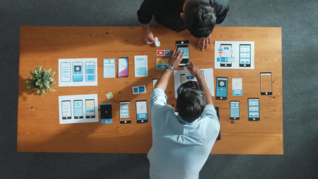 Top view of software developer working on Ux Ui design while team working together to brainstorm and develop wireframe prototype designing at creative digital company. Teamwork concept. Convocation.の写真素材
