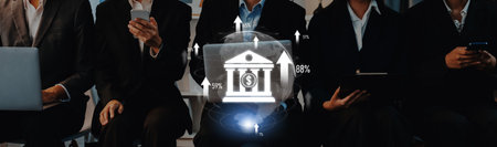 Business professionals in suits utilize technology while analyzing financial growth data, sitting in an office setting with digital graphics illustrating trends and patterns.の写真素材